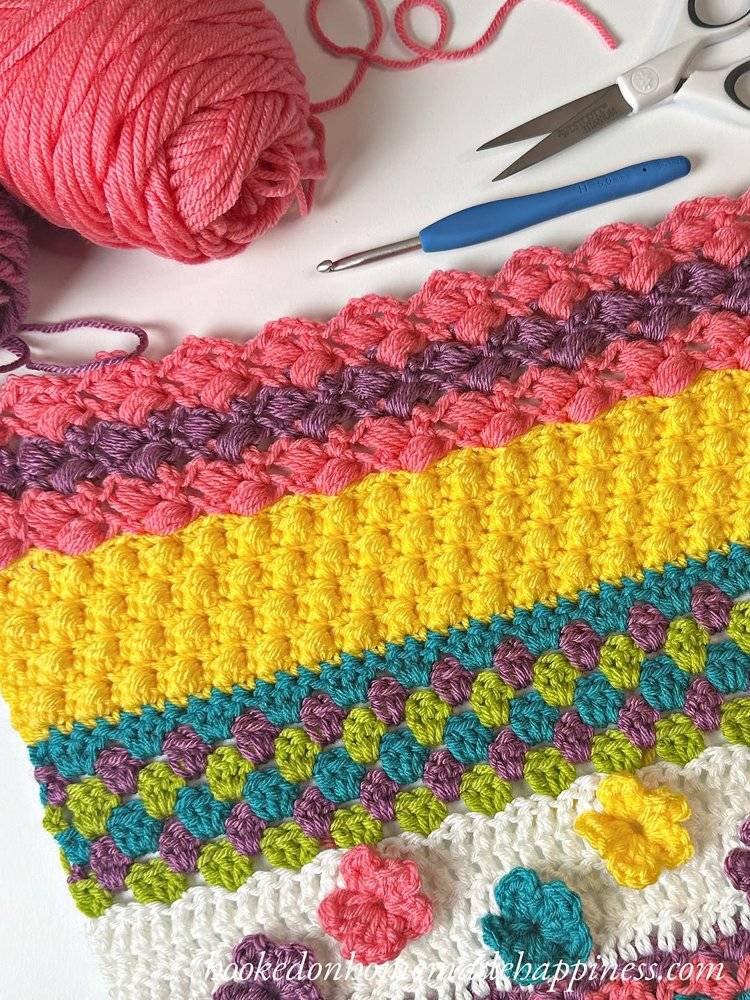 Vibrant Striped Crochet Blanket with Floral Accents