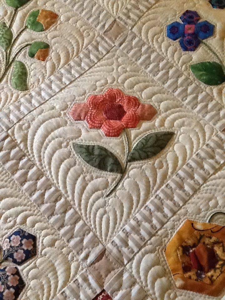 Intricate Feather Quilt Design with Floral Appliqué