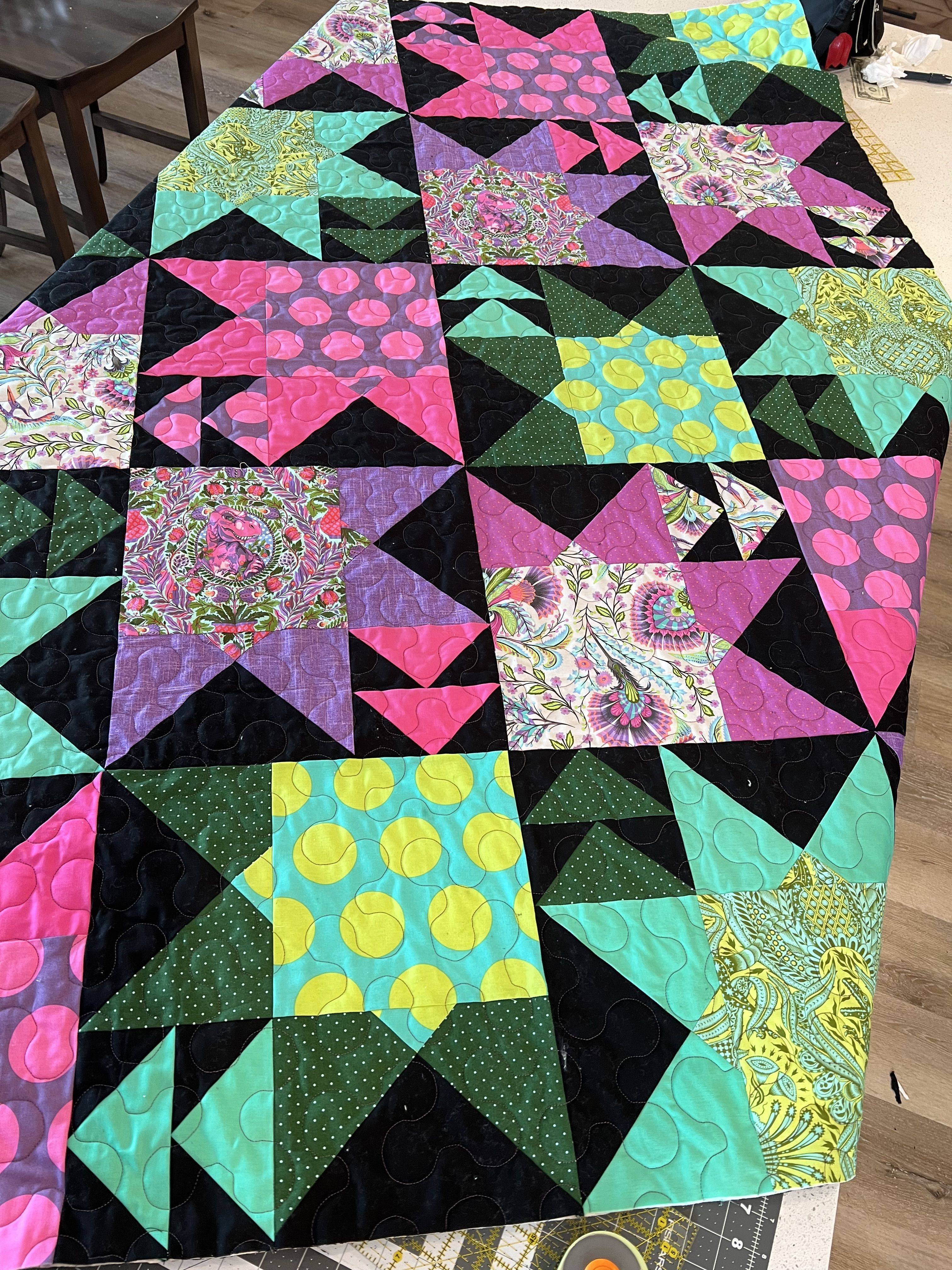 Vibrant Starburst Quilt with Geometric Triangle Patterns