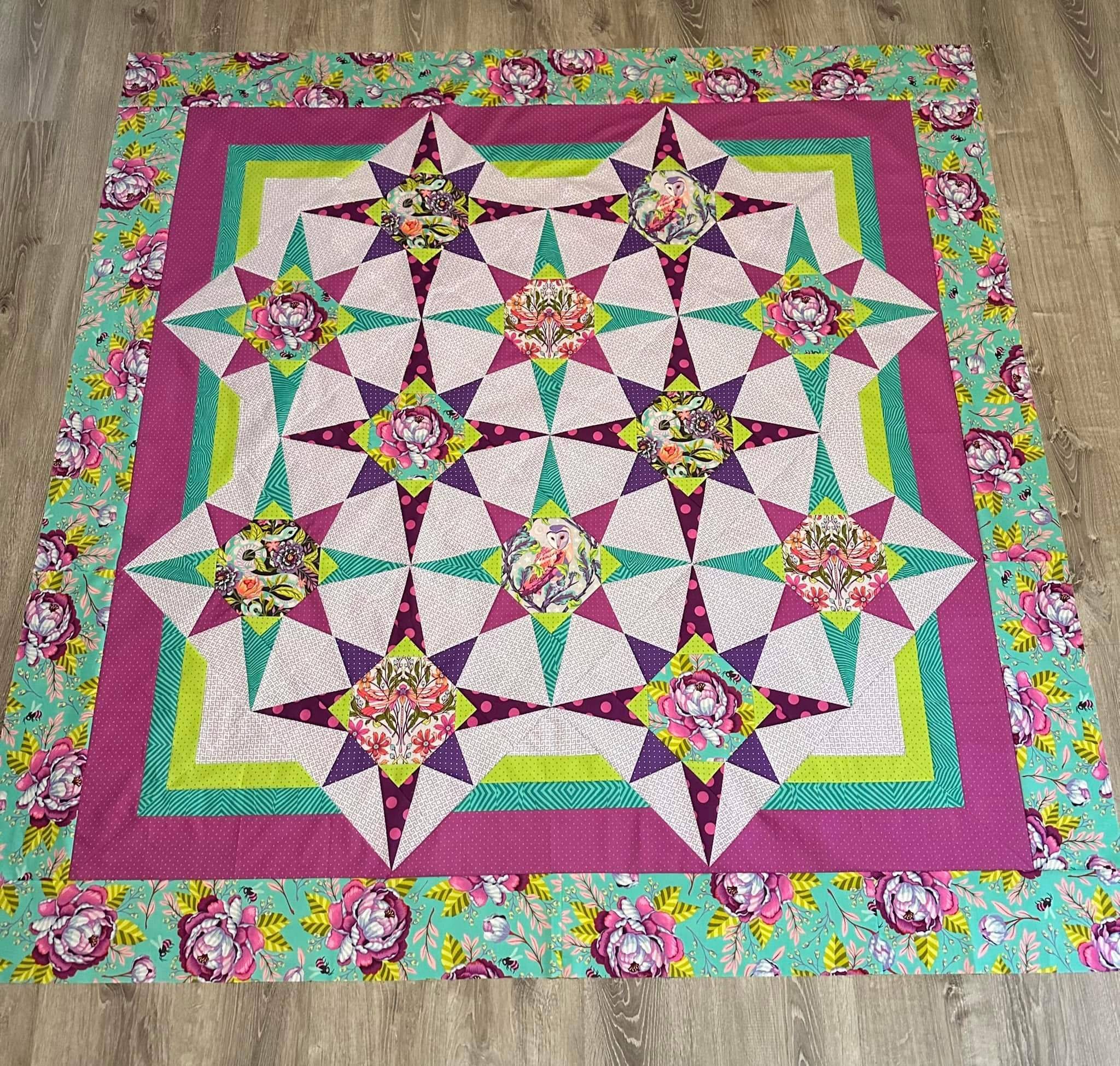Whimsical Starburst Quilt with Floral Border
