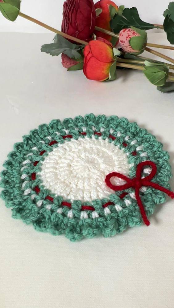 Festive Crochet Christmas Coaster with Red Bow