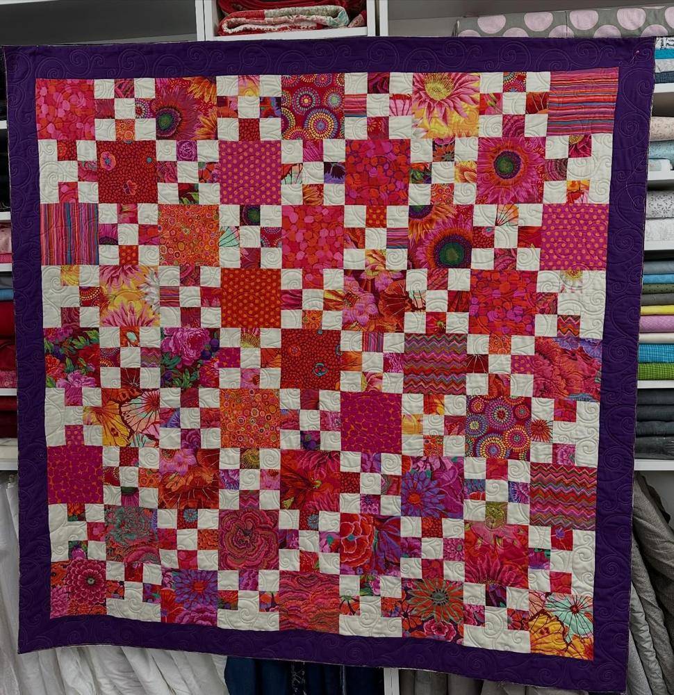 Vibrant Patchwork Quilt with Floral and Geometric Prints